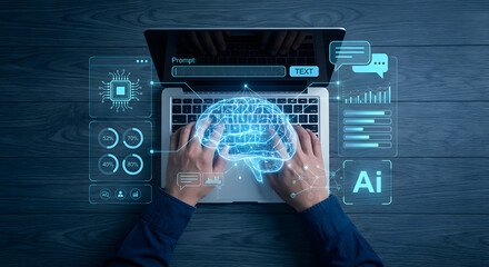 overhead view of hands typing on laptop with artificial intelligence glowing brain hologram and digital data interface for machine learning and neural network technology