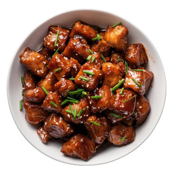 Glazed meat cubes with sesame seeds and chives in bowl isolated on white background