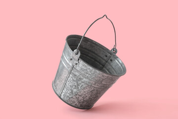 Galvanized bucket on pink background