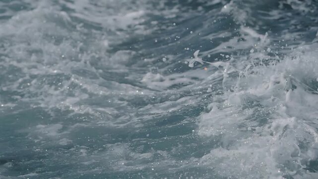 Ocean waves crash on the shore during afternoon hours