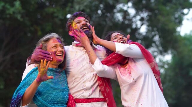 Happy indian man and woman playing holi colors