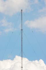 Mast radiator tower clouds blue sky background