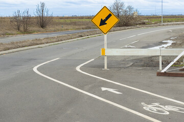 Truck driver navigating turn in Pleasant Grove California on road with signs for route guidance