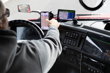 View from the driver's seat of a truck driving down the road in Pleasant Grove, California showing navigation tools in use by an experienced truck driver