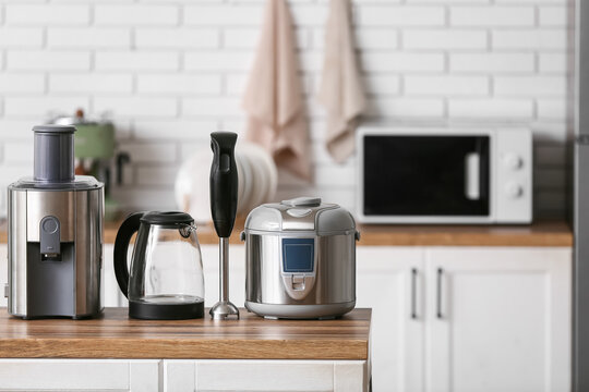 Different modern household appliances on counter in kitchen