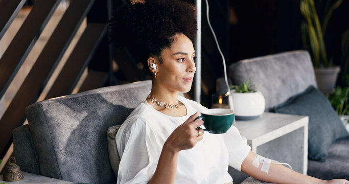 Woman, iv infusion and tea in drip lounge, healthcare and music for medical treatment and streaming. Clinic, recovery and person with earphones for wellness, immune system boost and relax with matcha