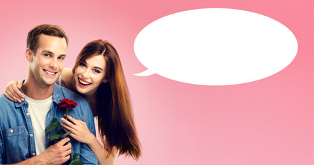 Love, relationship, dating, flirting, romantic concept - happy cute couple, man woman, girlfriend boyfriend wear casual denim cloth hold rose flower, isolated pink background with white speech bubble