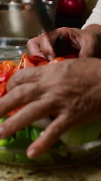 close up freshly diced red sweet peppers (venezuelan aj&iacute; dulce), onions, and green celery stalks in a bowl, showing the vibrant colors and textures of a homemade sofrito base