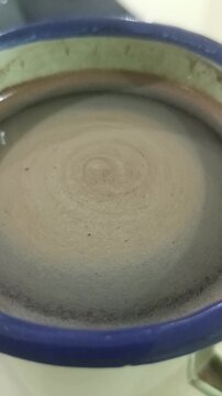 a glass of coffee in an old-fashioned cup