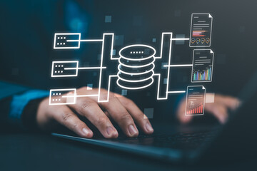 Businessman using a laptop to leverage business intelligence from a data warehouse an integrated database for business data analysis and strategic insights.