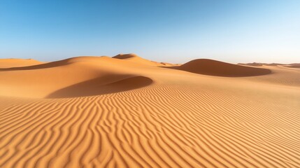 Vast, shimmering dunes of golden sand under a clear blue sky, showcasing the beauty of a serene desert landscape.