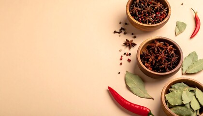 A flat lay showcases wooden bowls filled with various spices, alongside bay leaves and chili peppers, on a beige surface