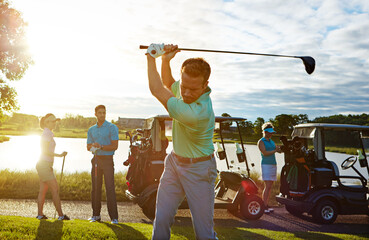 Obraz premium Sports, swing and man on course with golf challenge, tournament or game in nature at club. Lens flare, cart and male person with group of people for putter outdoor with hobby, training or skill.