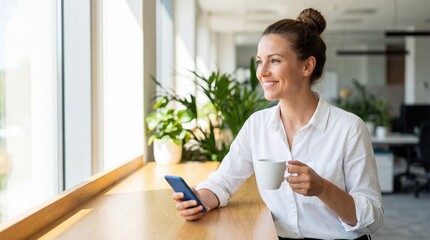 Smiling woman coffee smartphone window light modern office