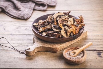 Pieces of dried mushrooms in bowl, preserving food