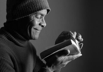 praying to god with hands showing his religious faith with God Caribbean man praying with black background with people stock photo stock image