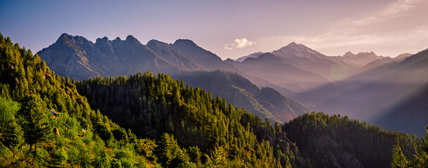 Panorama of the mountains. Majestic Golden Hour Over Sainj Valley, Himachal Pradesh. This serene landscape showcases the majestic Himalayan peaks and traditional mountain scenery of Northern India.