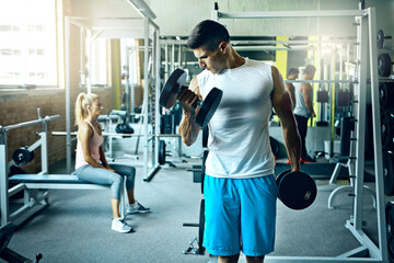 Power, dumbbells and man in gym, training and endurance for muscle growth, workout and strong....