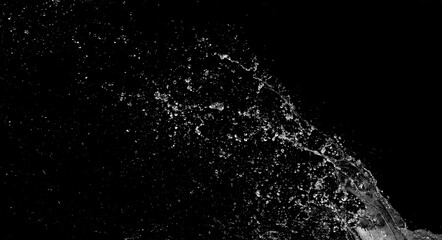 Obraz premium Diagonal sheet of water droplets splashing across dark frame, fine sparkling particles creating intense storm texture, realistic side rain overlay for cinematic scenes and dramatic designs