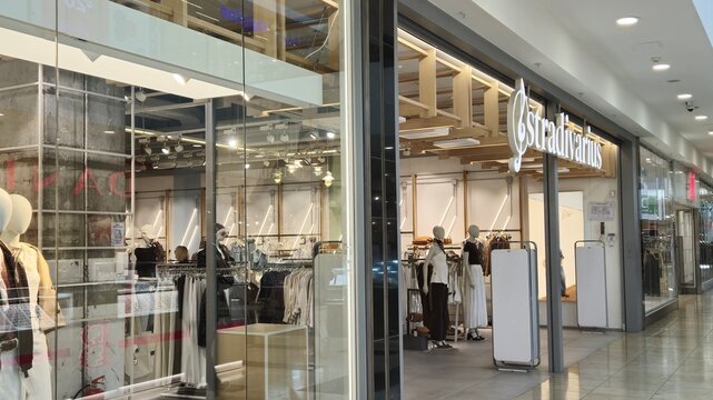 Vilnius Lithuania - 03.29.2025 Stradivarius clothing store entrance with mannequins in stylish outfits, racks of women&rsquo;s fashion garments and illuminated logo inside modern shopping mall interior
