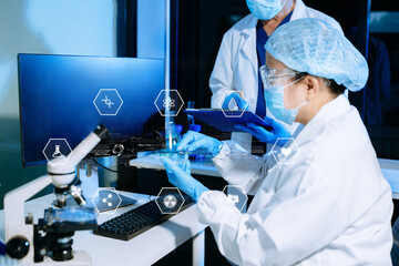 Medical scientists using digital technology and AI tools for laboratory research and diagnostics. Healthcare innovation, biotechnology, data-driven medicine