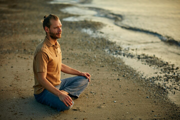 Man, thinking and meditation in nature, beach and yoga for inner peace, space or spiritual awareness. Outdoor, mindfulness and person with routine for stress relief, relax and wellness on holiday