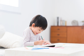 色鉛筆でお絵描きする子供1人