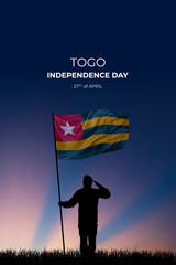 National flag of Togo flutters in military man hands