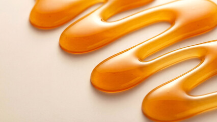 Obraz premium Abstract close up of golden, flowing honey on a bright background for food concepts