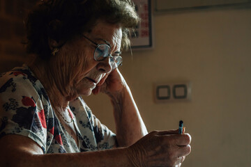 senior woman at home writing puzzles or crosswords