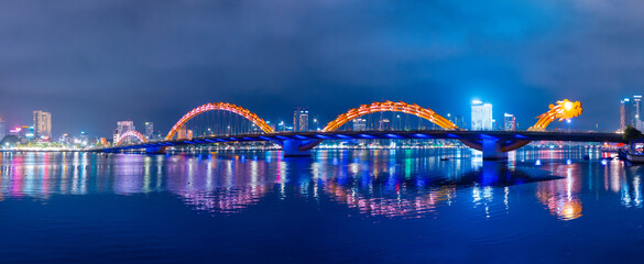 Night view of dragon bridge over han river in Da nang, Vietnam with illuminated skyline © Parilov