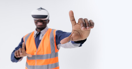 African male adult wearing vr headset in safety vest engaging with virtual interface