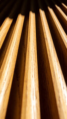Close-up of wooden slats with strong light and shadow creating abstract geometric pattern in modern interior