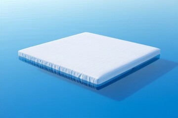 Serene mattress floating on calm blue water surface peacefully