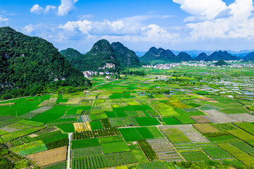 Green agricultural field and karst mountain natural landscape in Guilin, China.