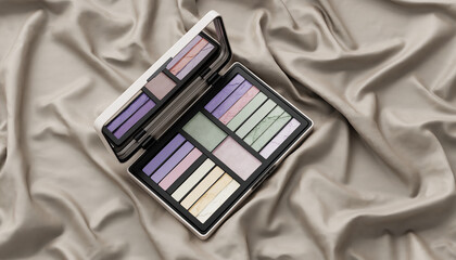 Open makeup palette featuring various shades of pastel eyeshadow and color correctors, resting on a luxurious, draped silk fabric in a neutral taupe color, ready for cosmetic application.