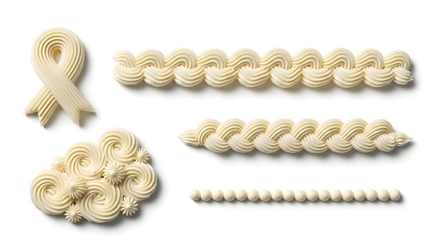 Various piped buttercream frosting patterns and borders isolated on white