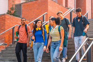 Obraz premium Diverse university students walking down stairs on campus
