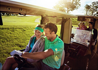 Couple, happy and driving in golf cart, laugh and conversation with social gathering in summer....