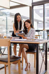 Two busy business professionals women and woman business leaders partners checking document reading...