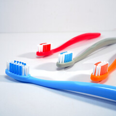 Vibrant toothbrushes pairing together on a sleek white background, evoking a sense of cleanliness and oral health, Daily routine concept photography