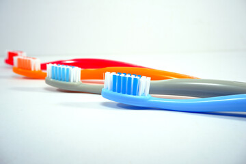 Vibrant toothbrushes pairing together on a sleek white background, evoking a sense of cleanliness and oral health, Daily routine concept photography