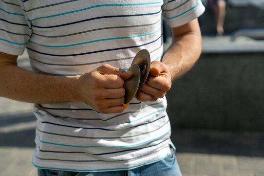 Playing Finger Cymbals (Zills) Outdoors &ndash; Close-Up of Hands
