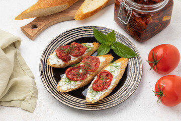 Sandwiches with sun-dried tomatoes on a plate on a table, created without generative AI