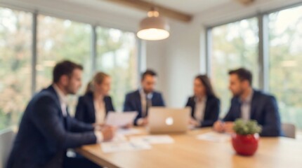 A focused group of five diverse business professionals are engaged in a collaborative discussion around a modern conference table in a well-lit office.