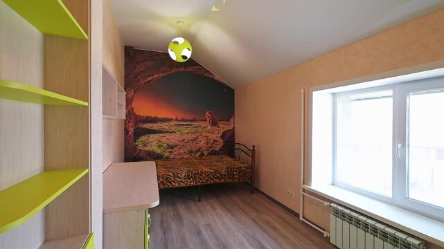cozy bedroom with a bed against a mural wall, bright green open shelves, a large window with a radiator, wooden flooring, and a ceiling light fixture.