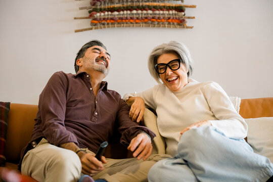 Senior couple sharing laughter and joy at home