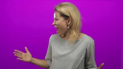Young blonde woman turns face to side exposing shiny golden hair in purple studio setting; curiosity.