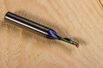 dlc milling cutter with carbide knives. carbon .cutter for processing aluminum. close-up on a light wooden background. carbide milling cutter. CNC tool. knives for non-ferrous metals and duralumin.