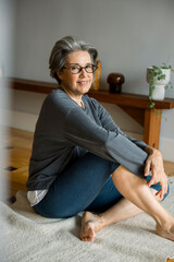 Obraz premium Mature woman enjoying wellness and mindful living at home